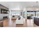 Spacious living room with hardwood floors, fireplace, built-in shelving, and sliding glass doors to the patio at 507 Red Thistle Dr, Highlands Ranch, CO 80126