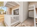 Exterior view of unit 102 with a private balcony, stone accents, and a well-maintained walkway at 14454 E Colorado Dr # 102, Aurora, CO 80012