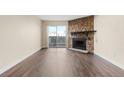 Bright living room features modern flooring, a stone fireplace, and access to the balcony at 14454 E Colorado Dr # 102, Aurora, CO 80012