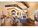 Spacious living room with high ceilings, exposed beams, and fireplace at 6 Ivy Ln, Denver, CO 80220