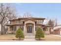 Stunning two-story home with a tile roof, symmetrical landscaping, and a grand entrance with pillars at 6246 W 35Th Ave, Wheat Ridge, CO 80033