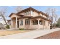 Beautiful home with a tile roof, columns, and mature landscaping, showcasing its architectural details at 6246 W 35Th Ave, Wheat Ridge, CO 80033