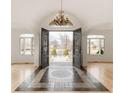 Inviting foyer with decorative tile flooring, a grand chandelier, and arched doorways leading to other rooms at 6246 W 35Th Ave, Wheat Ridge, CO 80033