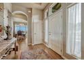 Welcoming foyer with hardwood floors, an arched entryway, and a glimpse of the dining area at 16192 St Lawrence Way, Monument, CO 80132