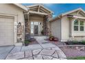 Inviting front entrance showcasing stone pillars, a gray front door, and a decorative walkway at 16192 St Lawrence Way, Monument, CO 80132