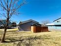 The exterior features blue siding, complemented by a rich, wooden fence for a welcoming yard aesthetic at 1049 W 112Th Ave # A, Denver, CO 80234