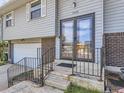Close-up of the home's entrance featuring double doors, brick accents, and well-kept walkway at 1488 W 102Nd Ave, Northglenn, CO 80260