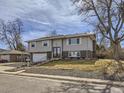 View of a charming two-story home with light gray siding and well-maintained front yard at 1488 W 102Nd Ave, Northglenn, CO 80260