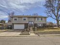 Charming two-story home with light gray siding, attached garage, and well-maintained front yard at 1488 W 102Nd Ave, Northglenn, CO 80260