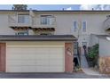 Townhouse exterior with a two-car garage and entrance at 112 S Holman Way, Golden, CO 80401