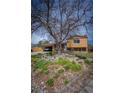 Charming home with rock garden, mature tree in yard, driveway, and a brick and siding exterior at 1562 Madison Ct, Louisville, CO 80027