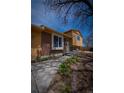 Inviting home with brick and siding exterior, walkway, and landscaping at 1562 Madison Ct, Louisville, CO 80027