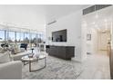 Open-concept living room with a large window, sleek furniture, and view of greenery at 1201 N Williams St # 3A, Denver, CO 80218
