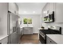 Updated kitchen with stainless steel appliances, gray cabinetry, and bright countertops at 1035 S Garfield St, Denver, CO 80209