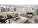 Inviting living room featuring hardwood floors, large windows, comfortable seating, and modern decor at 1035 S Garfield St, Denver, CO 80209
