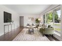 Bright living room with hardwood floors, large window, and stylish furniture at 1035 S Garfield St, Denver, CO 80209