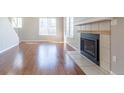 This bright living room is complete with wood floors and a tiled fireplace at 12743 Eudora Dr, Thornton, CO 80241