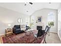Bright living room featuring vaulted ceilings, fireplace, and large arched windows at 2360 Santa Fe Dr # B, Longmont, CO 80504