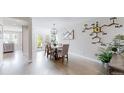 Elegant dining room featuring a stylish chandelier, contemporary artwork, and seamless kitchen access at 2353 S Jamaica St, Aurora, CO 80014