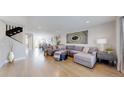 Spacious living room with hardwood floors, a large sectional sofa, and stylish decor at 2353 S Jamaica St, Aurora, CO 80014