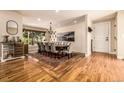 Spacious dining room features a large wooden table, comfortable seating, and attractive hardwood floors at 6963 E Heritage S Pl, Centennial, CO 80111