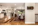 Open-concept dining room with hardwood floors, a large wooden table, and ample natural light at 6963 E Heritage S Pl, Centennial, CO 80111