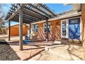 Inviting brick patio with a stylish pergola, cozy seating, and a welcoming entrance to the home at 1835 S Poplar St, Denver, CO 80224