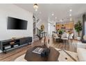 Spacious living area with an open floor plan, flowing into the dining area and kitchen at 2121 Barnwood Dr, Brighton, CO 80601