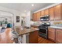 Well-lit kitchen with granite countertops, stainless steel appliances and a center island with seating at 2846 Central Park Blvd, Denver, CO 80238