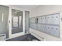 Mailroom with secure mailboxes and a glass entry door, ensuring resident privacy at 75 N Emerson St # 206, Denver, CO 80218