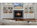 Elegant living room featuring a fireplace, built-in bookshelves, and a comfortable seating area at 1051 S York St, Denver, CO 80209
