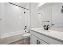 Stylish bathroom features black fixtures, white subway tiles, a tub, and a white vanity with quartz countertop at 1121 Joseph Pl, Erie, CO 80026