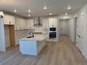 Spacious kitchen with white cabinets, stainless steel appliances, and an island with a sink at 1121 Joseph Pl, Erie, CO 80026