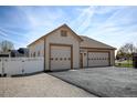Detached two-car garage featuring neutral siding, paneled doors, and a well-lit exterior at 16350 Timber Cove St, Hudson, CO 80642