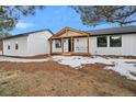 Charming home exterior with a welcoming front porch, black-framed windows, and fresh landscaping at 11840 Elkhorn Dr, Franktown, CO 80116