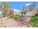 Street view of charming single-story home with driveway and manicured front yard at 4120 S Lincoln S St, Englewood, CO 80113