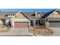 Charming home with a two-car garage, a covered entry, and manicured landscaping at 14434 W 88Th Dr # B, Arvada, CO 80005