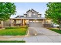 Attractive two-story home featuring a well-manicured lawn, two-car garage and stylish exterior at 4738 Colorado River Dr, Firestone, CO 80504