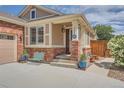 Charming front porch with brick accents and well-kept landscaping at 20058 E Dartmouth Dr, Aurora, CO 80013
