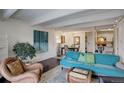 Cozy living room with a comfortable sofa and a view into the dining area and the kitchen at 1433 N Williams St # 407, Denver, CO 80218