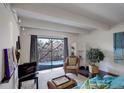 Bright living room with hardwood floors, balcony access, and stylish decor at 1433 N Williams St # 407, Denver, CO 80218
