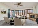 Bright living room with stone fireplace, large windows, and comfortable seating at 12771 W 6Th Pl, Lakewood, CO 80401