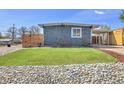 Inviting front yard with lush green grass and decorative rock landscaping for enhanced curb appeal at 5000 W Dakota Ave, Denver, CO 80219