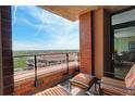 Relaxing balcony featuring comfortable seating, a brick facade and an incredible scenic view of the city at 8100 E Union Ave # 1502, Denver, CO 80237