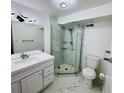 Bathroom features a glass-enclosed shower, modern vanity, stylish lighting, and elegant white and marble tile at 1155 N Ash St # 908, Denver, CO 80220