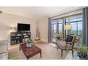 Cozy living room featuring a city view from the balcony, warm natural light, and neutral decor at 800 N Pearl St # 1109, Denver, CO 80203