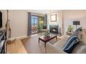 Inviting living room with a fireplace, balcony access, and comfortable seating at 800 N Pearl St # 1109, Denver, CO 80203