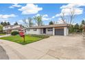 Cozy one-story home with a concrete driveway, and attractive landscaping at 8622 W Warren Ln, Lakewood, CO 80227