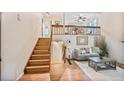 Cozy living room with an upstairs loft, hardwood floors, and a comfortable sitting area that offers a welcoming space at 5602 S Yank Ct, Littleton, CO 80127