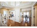 Bright foyer with hardwood floors, staircase, and views to the formal living room and dining room at 6275 Lakewood Rd, Parker, CO 80134